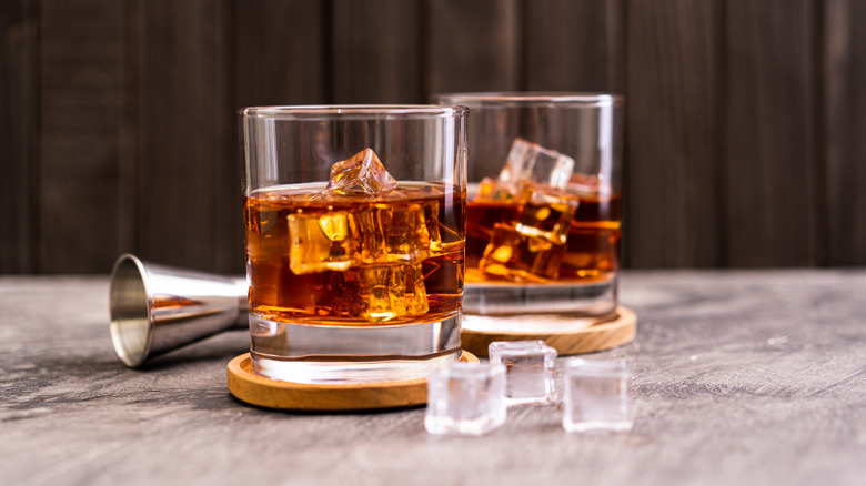 Two glasses of bourbon with ice