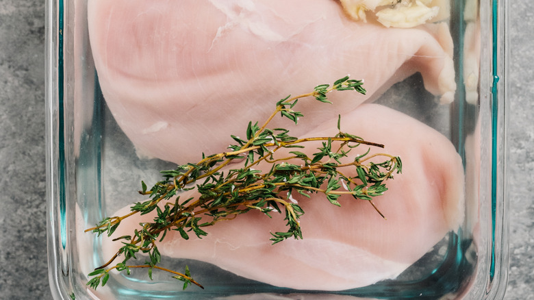 brined chicken in glass dish