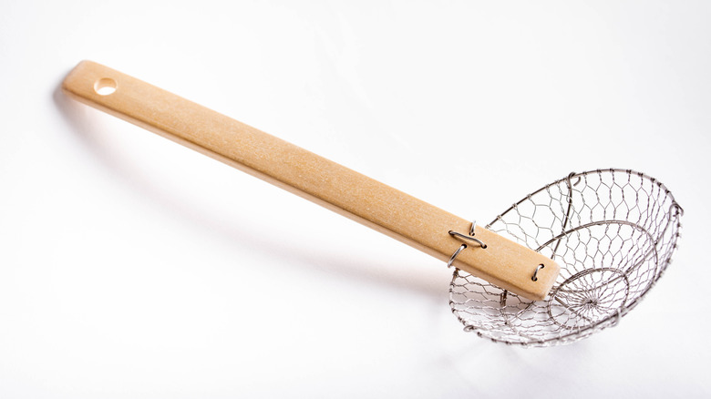 Spider strainer on white background