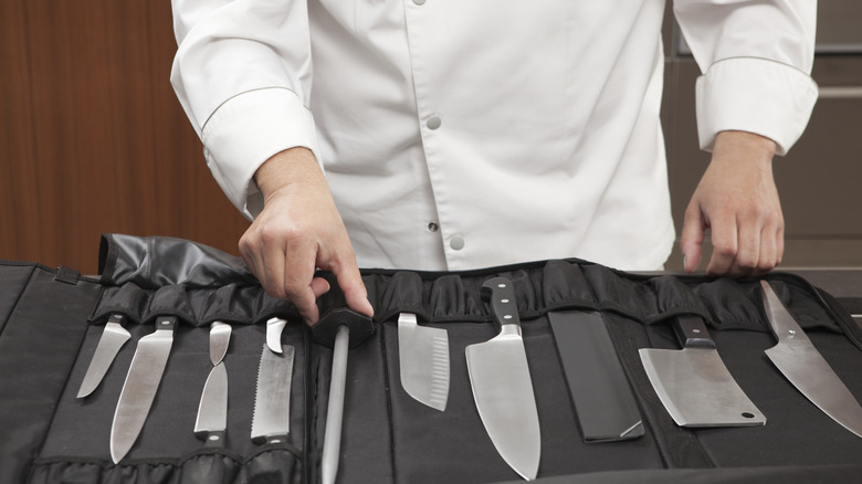 A knife roll with a selection of various chef knives