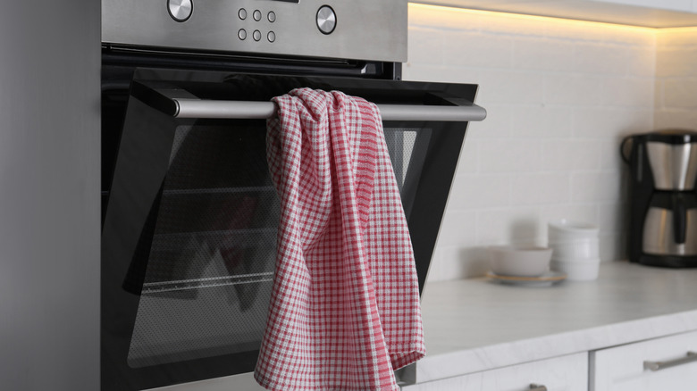 Kitchen towel hanging on oven door