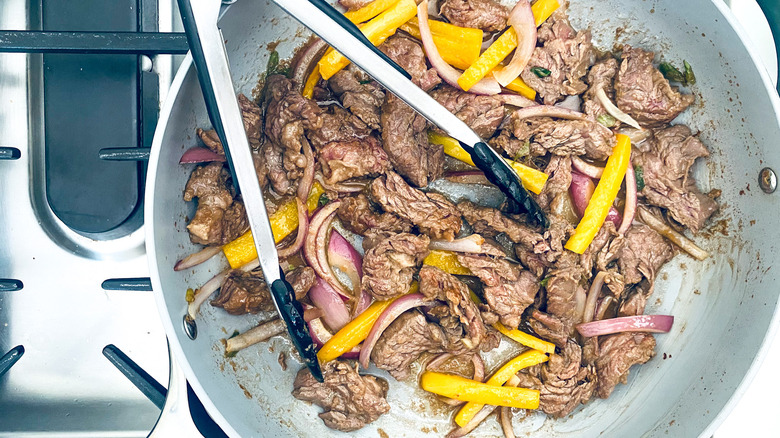 veggies and steak in skillet 