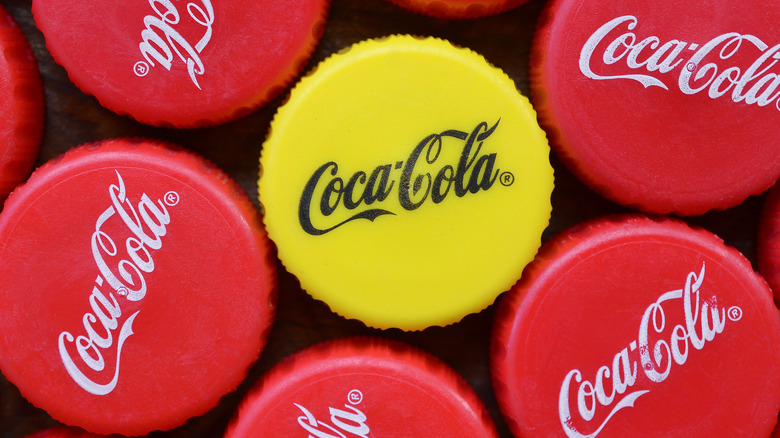 yellow and red Coke caps