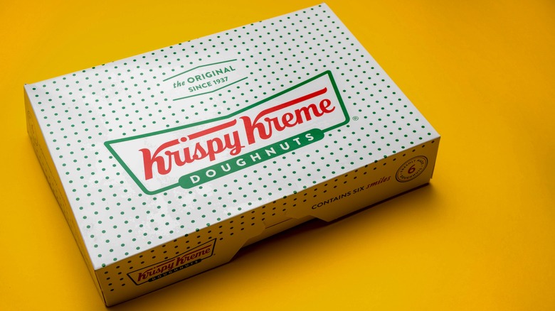 Box of Krispy Kreme on yellow background