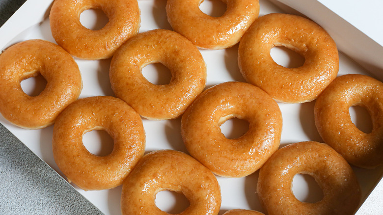 dozen of Krispy Kreme donuts in a box