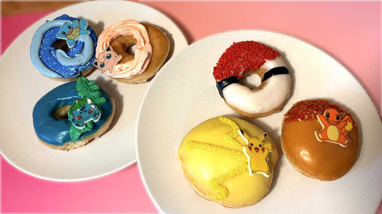 variety of pokemon themed krispy kreme donuts on plates