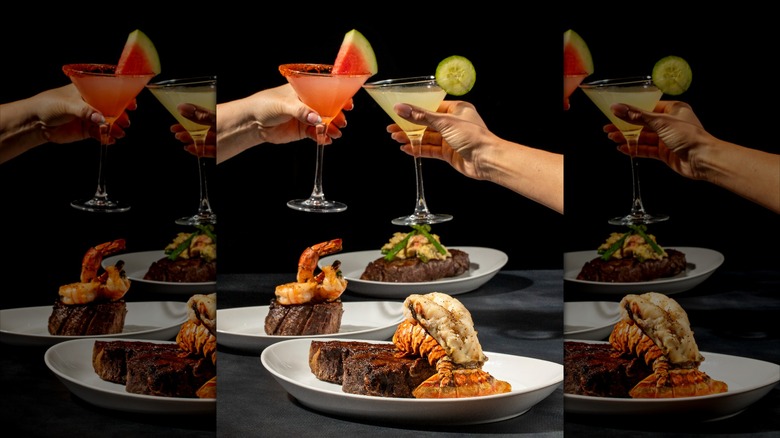 People clinging glasses over plate of steak
