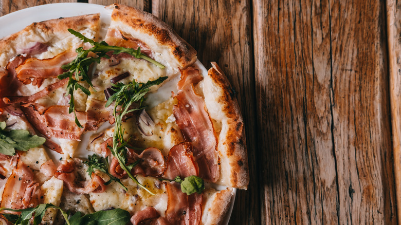 Pizza topped with arugula