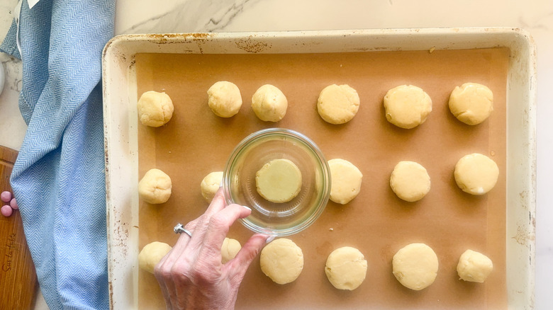 hand using glass to flatten