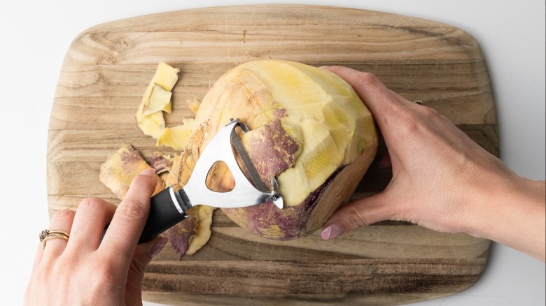 peeling rutabaga with vegetable peeler
