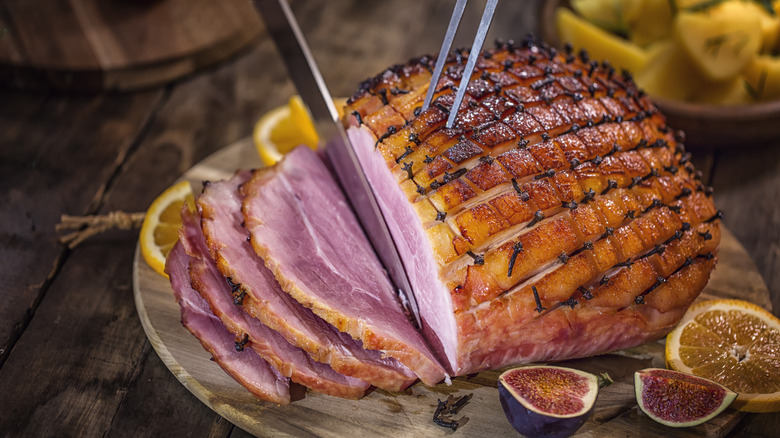 Glazed ham being cut