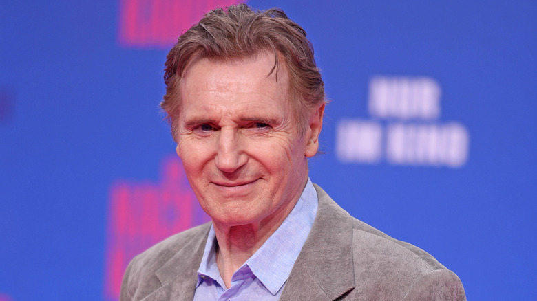 Liam Neeson smiles at event