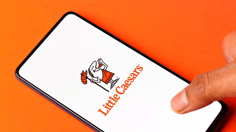 A person using the little caesars app
