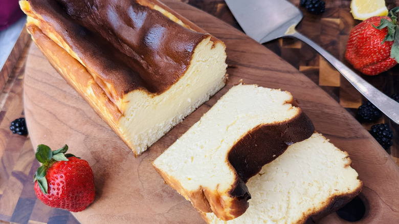 Loaf pan Basque cheesecake sliced on wooden board