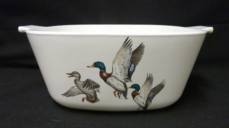 A white casserole dish with three flying ducks on the outside