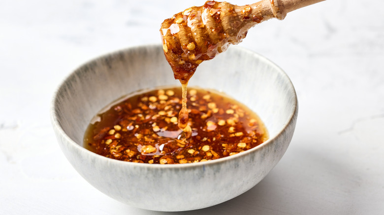 Bowl of hot honey on a white surface
