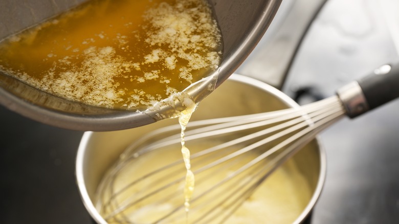 whisking butter into a hollandaise sauce
