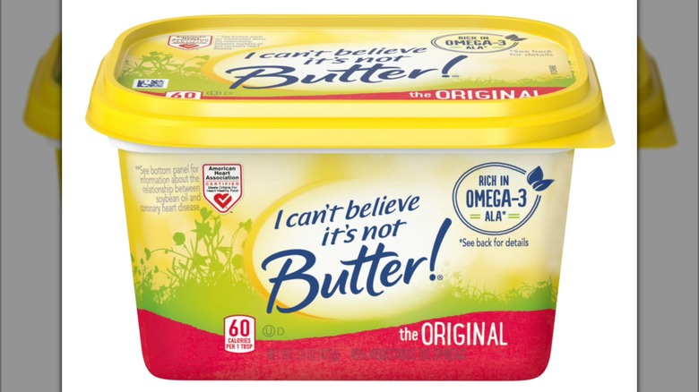 A sealed tub of I Can't Believe It's Not Butter positioned against a white background