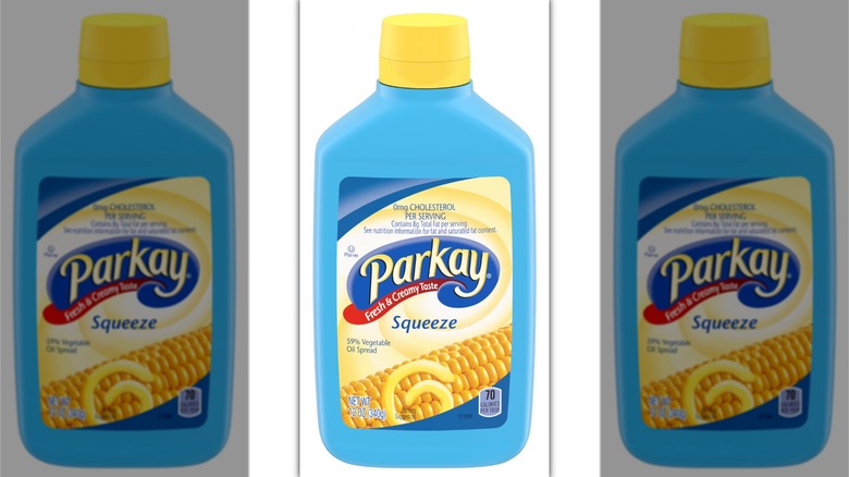 A blue bottle of Parkay Squeeze Vegetable Oil Spread on a white background