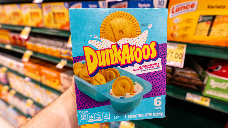 A hand holding a box of Dunkaroos
