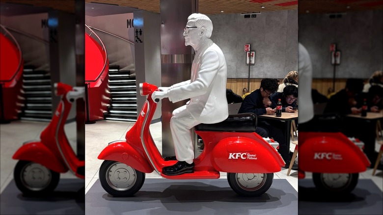 The inside of the KFC store in Rome with a 3d model of the colonel on a vespa