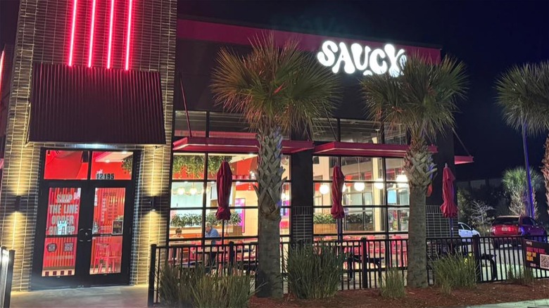 Exterior shot of a Saucy outlet at dusk