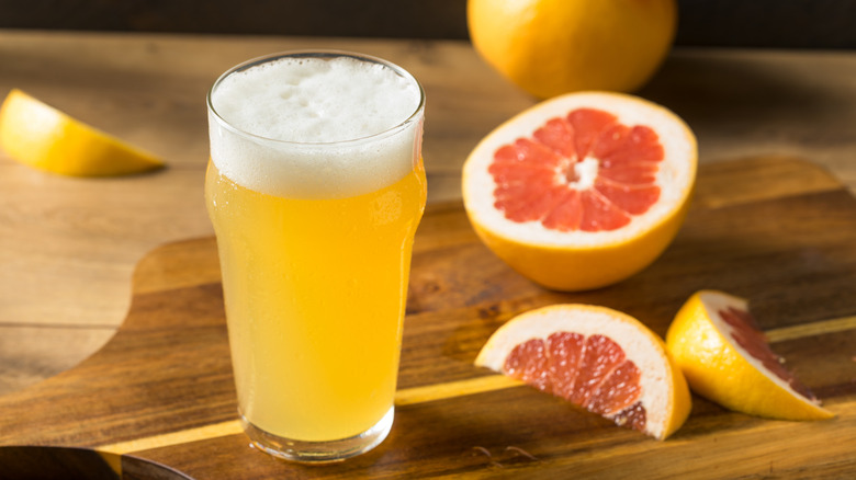 Glass of grapefruit radler with sliced grapefruit