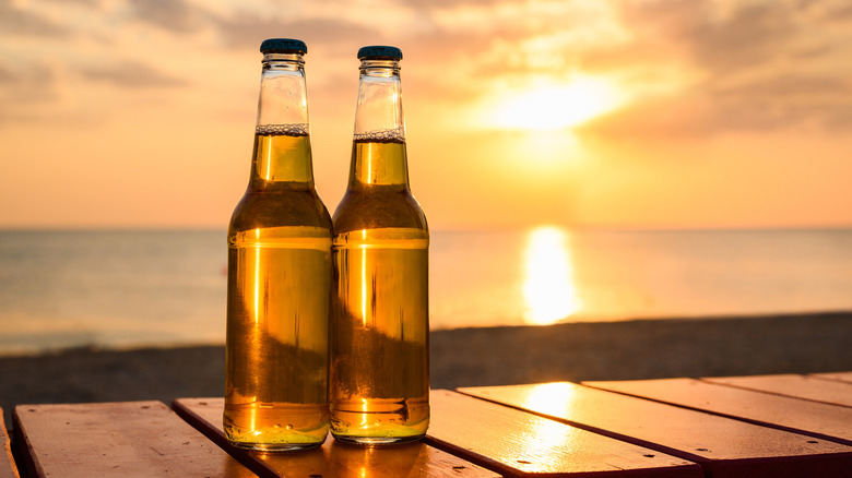 Clear glass beer bottles on a beach