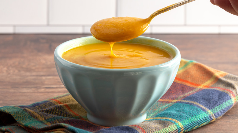 Sweet Potato and Sage Soup on a Rustic Wooden Table