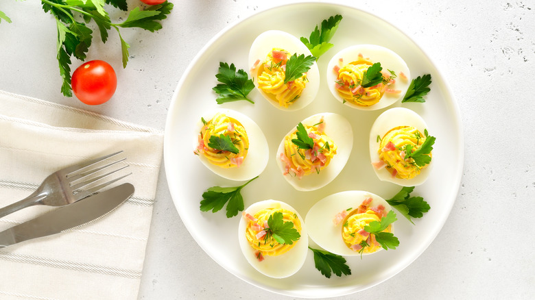 A plate of deviled eggs with parsley