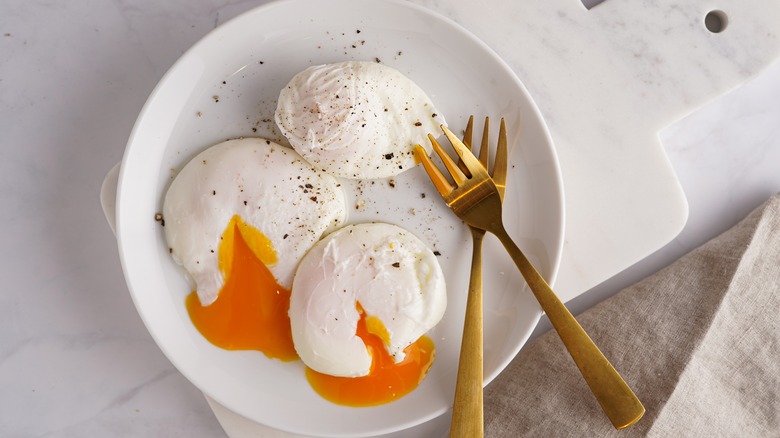 Three poached eggs on plate
