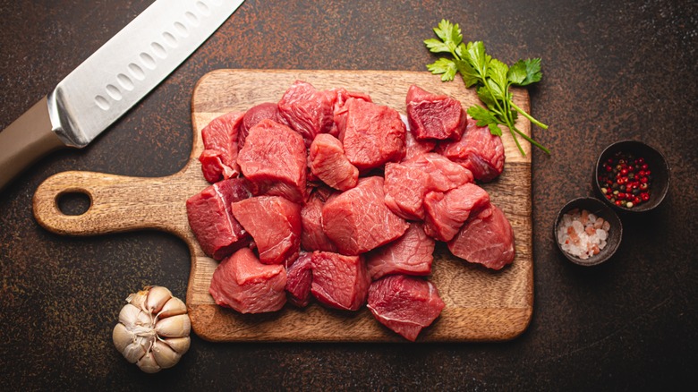 Chunks of stew meat on a cutting board