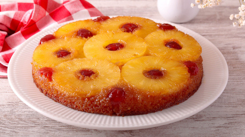 A pineapple upside down cake on a white plate