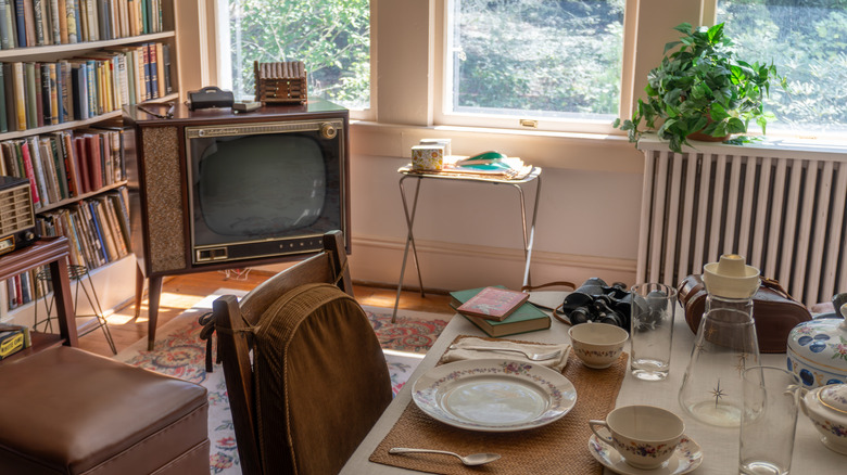 An old-style home with a tv tray, tv, and dining table