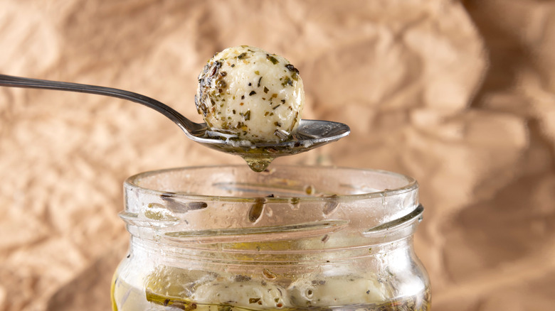Marinated mozzarella ball on a spoon