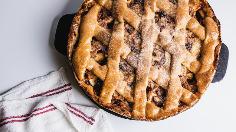 Closeup of apple pie with white and red towel