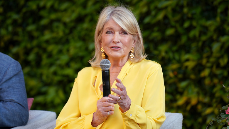 Martha Stewart wearing yellow and speaking into a microphone