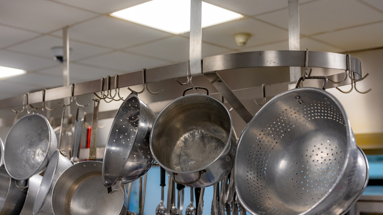 Pots and pans hanging from a ceiling rack