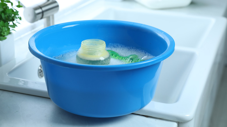 Plastic tub with items soaking in it