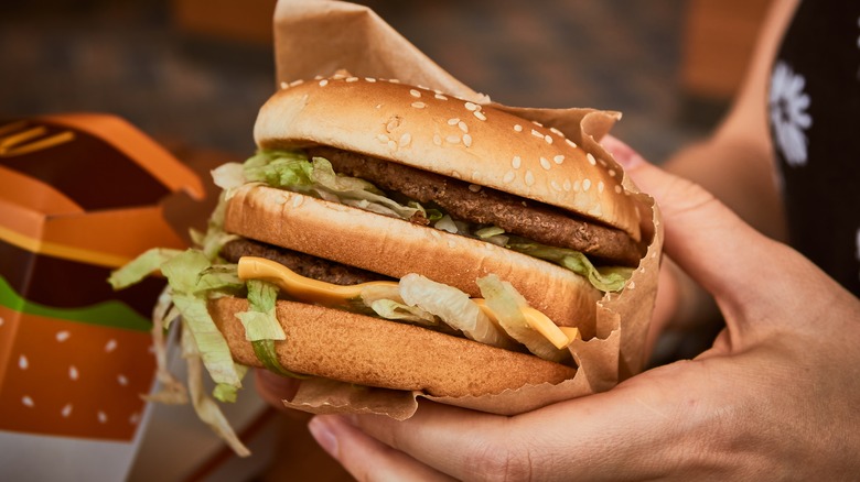 Women holding McDonald's Big Mac sandwich