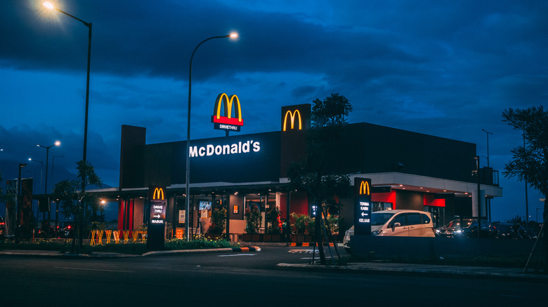 The exterior of a McDonald's location on an overcast night