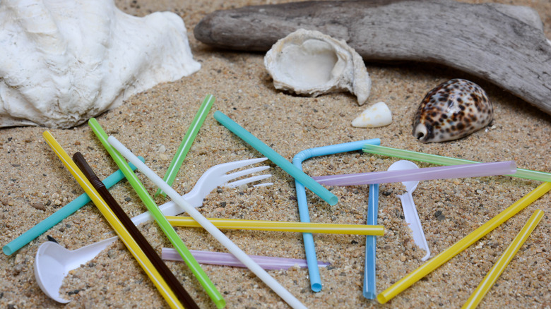 Plastic straws and utensils on beach