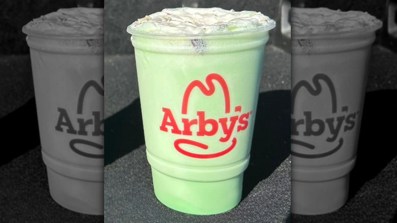 Arby's mint green milkshake against a dark background