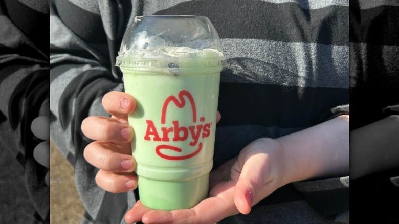 Arby's Andes Mint Chocolate Shake held in a person's hands