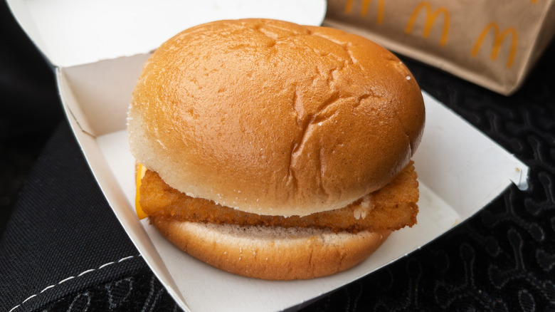 A fish sandwich in a McDonald's takeout box