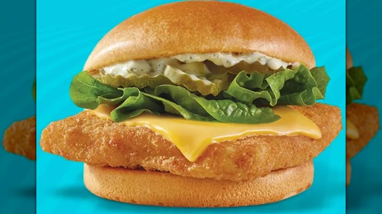 Wendy's Crispy Panko Fish Sandwich showing tartar sauce, lettuce, pickles, and American cheese