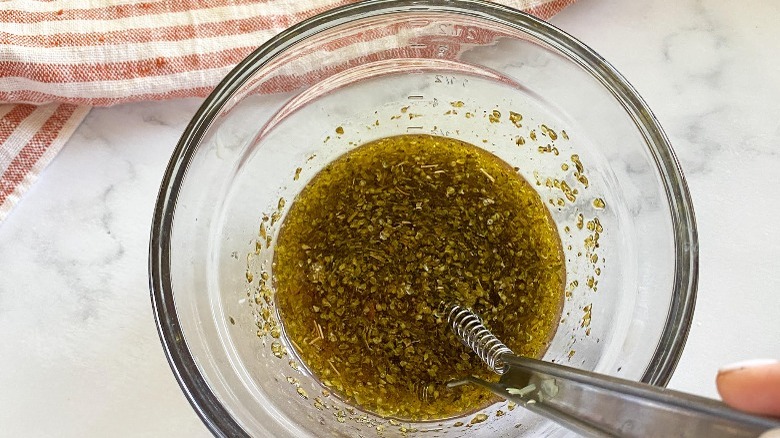 whisking dressing in small bowl