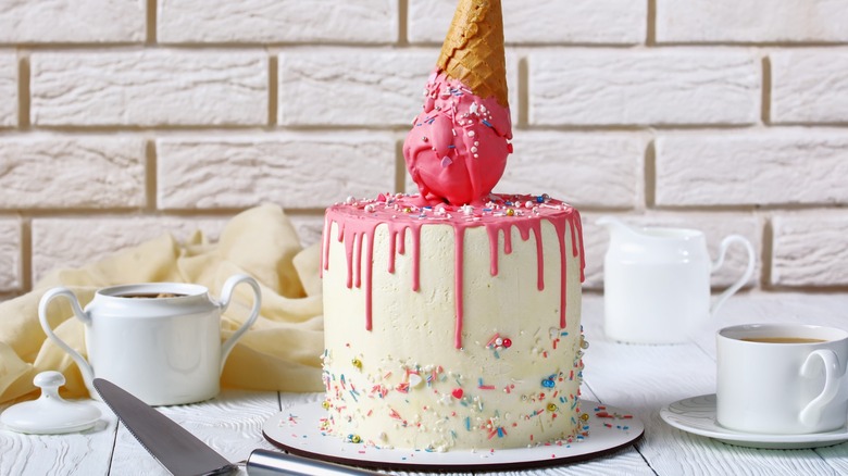 Melting ice cream cone atop a cake