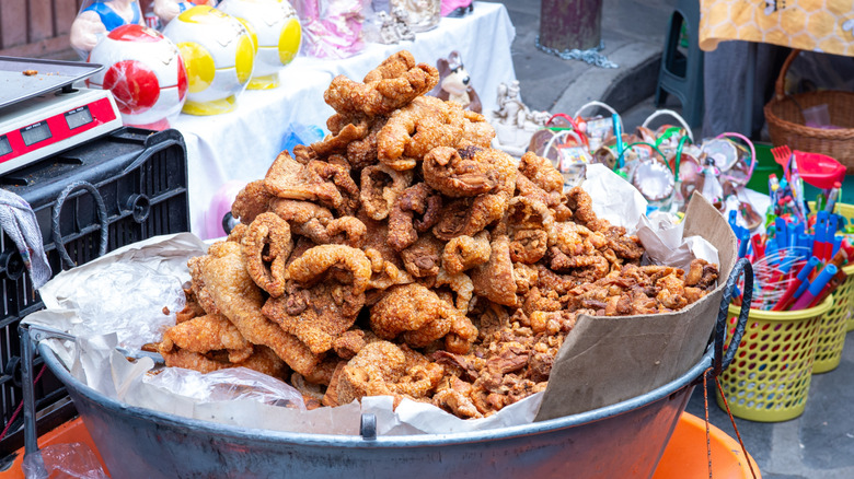 A pile of fried pork chicharrón for sale by the pound
