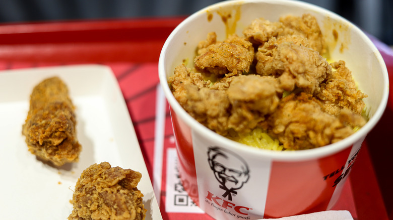 a bucket of KFC fried chicken on a table